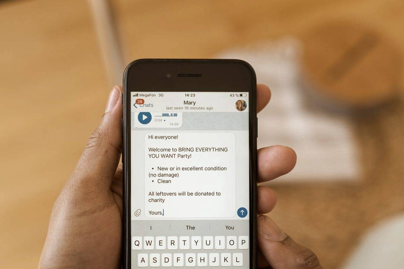 Close-up of hands typing a message on a smartphone